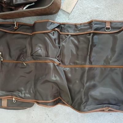 Suitcase with an assortment of bags and a two wheeled adjustable luggage cart