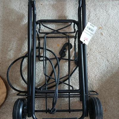 Suitcase with an assortment of bags and a two wheeled adjustable luggage cart