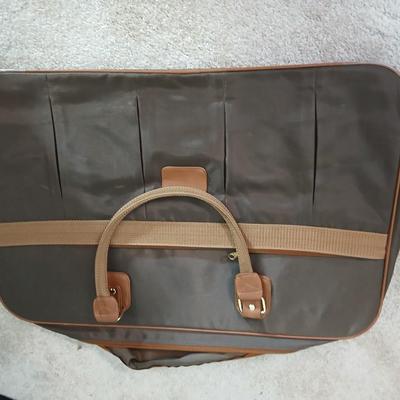 Suitcase with an assortment of bags and a two wheeled adjustable luggage cart