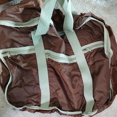 Suitcase with an assortment of bags and a two wheeled adjustable luggage cart