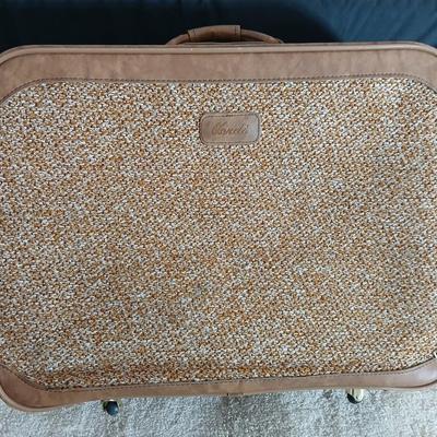 Suitcase with an assortment of bags and a two wheeled adjustable luggage cart