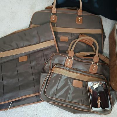 Suitcase with an assortment of bags and a two wheeled adjustable luggage cart