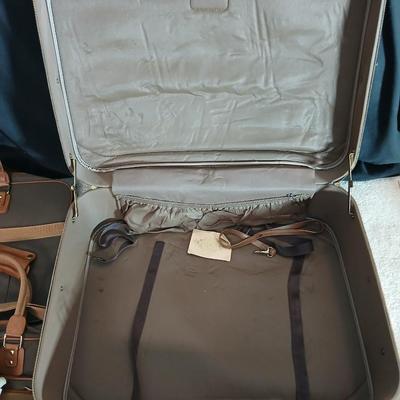 Suitcase with an assortment of bags and a two wheeled adjustable luggage cart