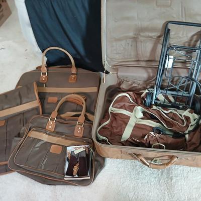 Suitcase with an assortment of bags and a two wheeled adjustable luggage cart