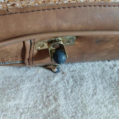 Suitcase with an assortment of bags and a two wheeled adjustable luggage cart