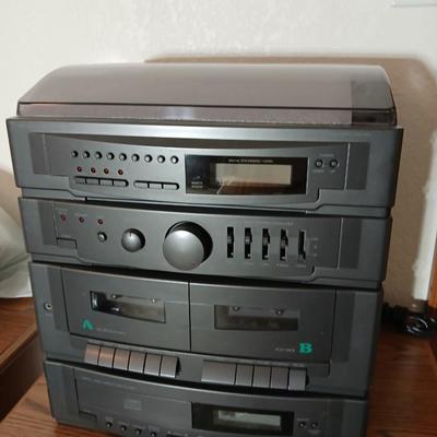Stereo system CD player, Tuner, Dual cassette, Record player with 2 speakers and collection of cd's and cassettes
