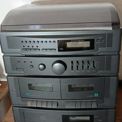 Stereo system CD player, Tuner, Dual cassette, Record player with 2 speakers and collection of cd's and cassettes
