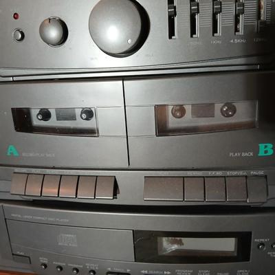 Stereo system CD player, Tuner, Dual cassette, Record player with 2 speakers and collection of cd's and cassettes