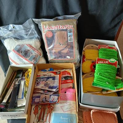 Skeins of yarn, new zippers, stretch lace edging, and other crafting / sewing items