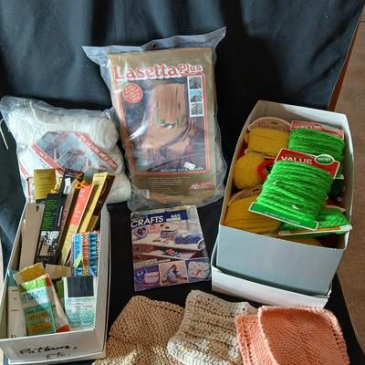 Skeins of yarn, new zippers, stretch lace edging, and other crafting / sewing items