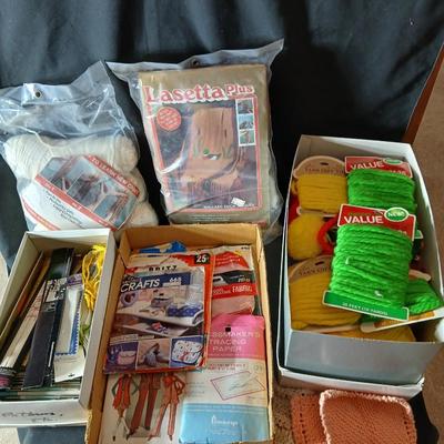 Skeins of yarn, new zippers, stretch lace edging, and other crafting / sewing items