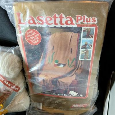 Skeins of yarn, new zippers, stretch lace edging, and other crafting / sewing items