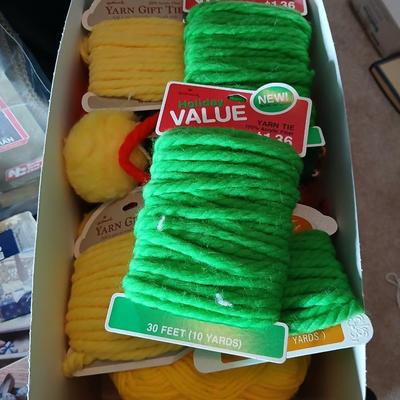 Skeins of yarn, new zippers, stretch lace edging, and other crafting / sewing items