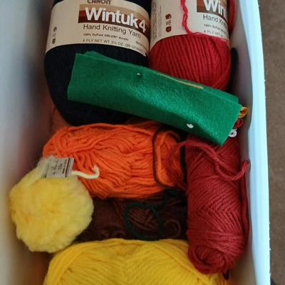 Skeins of yarn, new zippers, stretch lace edging, and other crafting / sewing items