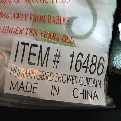Green Mist bathrug with matching towels and a shower curtain