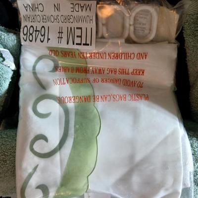 Green Mist bathrug with matching towels and a shower curtain