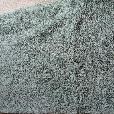 Green Mist bathrug with matching towels and a shower curtain