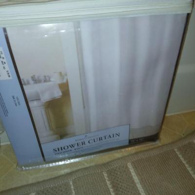 Two rubber backed rugs with a new shower curtain liner