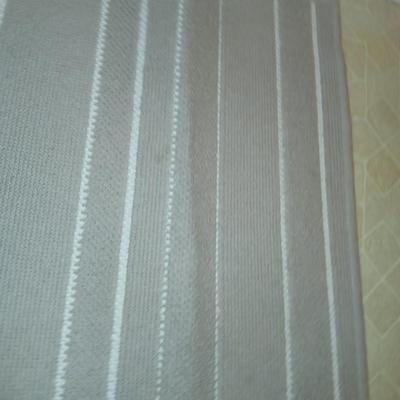 Two rubber backed rugs with a new shower curtain liner