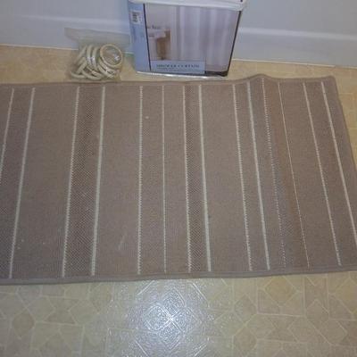 Two rubber backed rugs with a new shower curtain liner