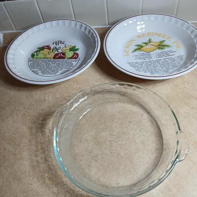 Two ceramic recipe pie dishes and one glass Pyrex pie dish
