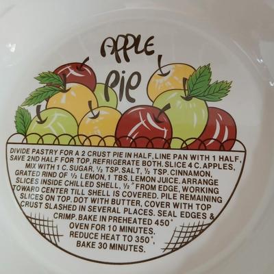 Two ceramic recipe pie dishes and one glass Pyrex pie dish