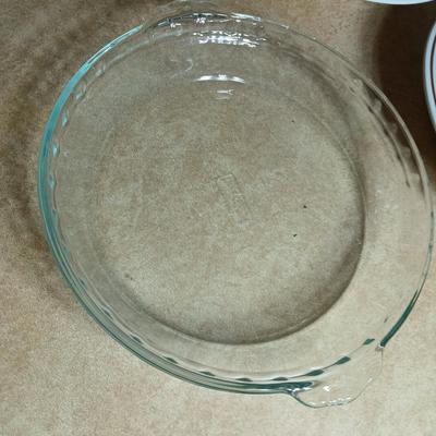 Two ceramic recipe pie dishes and one glass Pyrex pie dish
