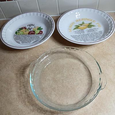 Two ceramic recipe pie dishes and one glass Pyrex pie dish