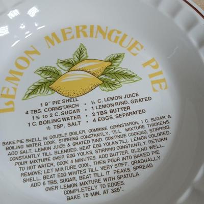 Two ceramic recipe pie dishes and one glass Pyrex pie dish