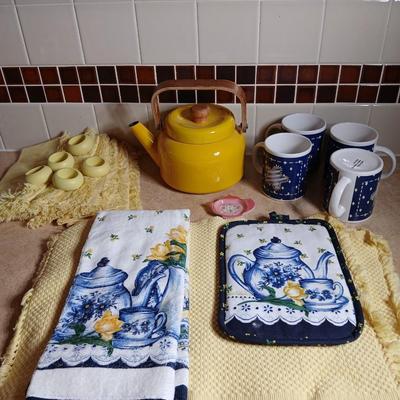Neat enamel yellow tea pot with star fun mugs and tea themed towels to match