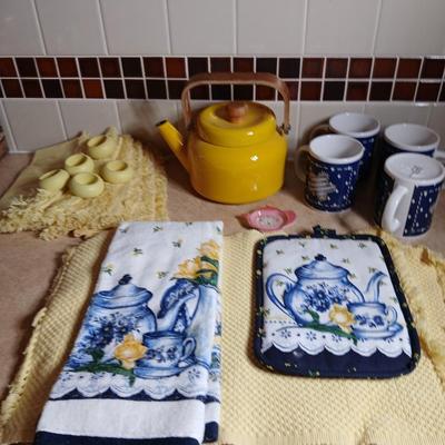 Neat enamel yellow tea pot with star fun mugs and tea themed towels to match