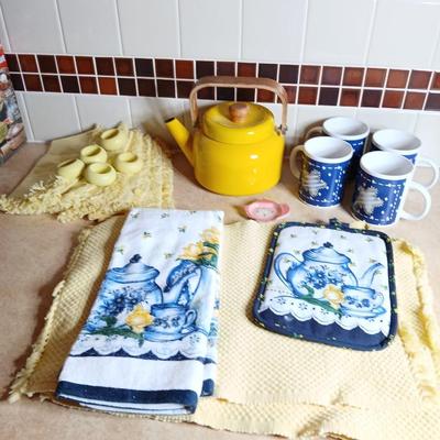Neat enamel yellow tea pot with star fun mugs and tea themed towels to match