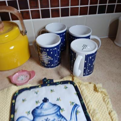 Neat enamel yellow tea pot with star fun mugs and tea themed towels to match