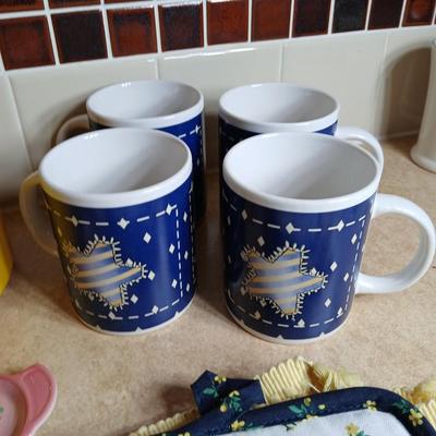 Neat enamel yellow tea pot with star fun mugs and tea themed towels to match