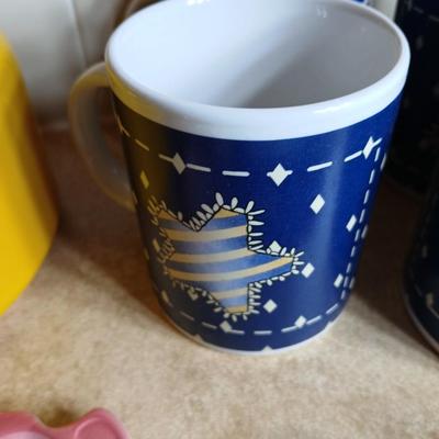 Neat enamel yellow tea pot with star fun mugs and tea themed towels to match