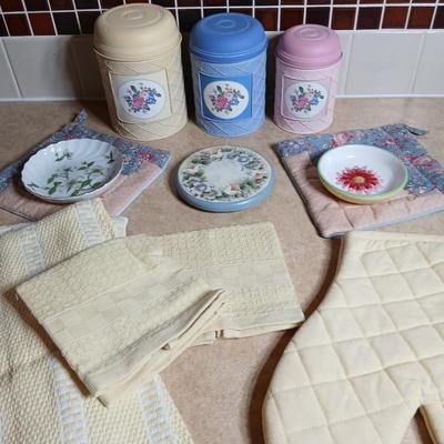 Small metal kitchen canister set with new kitchen towels and hot hand pad