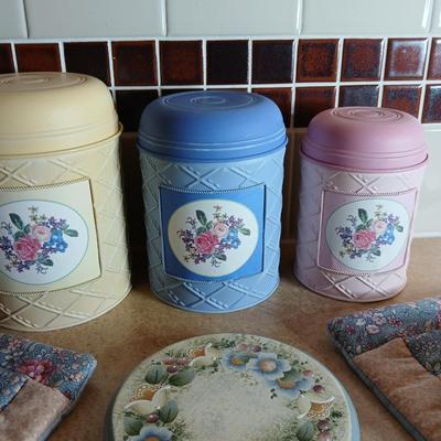 Small metal kitchen canister set with new kitchen towels and hot hand pad