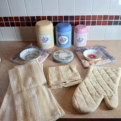 Small metal kitchen canister set with new kitchen towels and hot hand pad