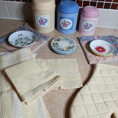 Small metal kitchen canister set with new kitchen towels and hot hand pad