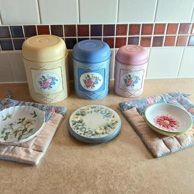 Small metal kitchen canister set with new kitchen towels and hot hand pad