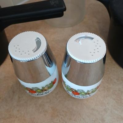 Pampered Chef pasta bowls with strainer lids, a glass spaghetti noodle canister and Italian themed salt & pepper shakers