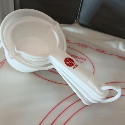 Baking items - measuring cup, Tupperware pad, small kitchen scale, rolling pin and a mixing bowl