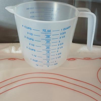Baking items - measuring cup, Tupperware pad, small kitchen scale, rolling pin and a mixing bowl