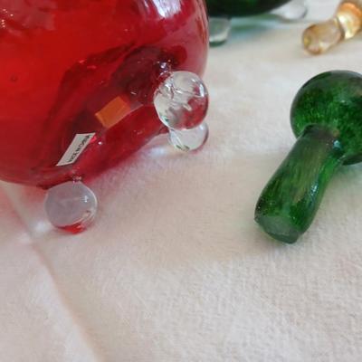 Two glass pears with a glass apple with removable stems