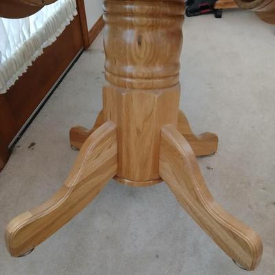 Beautiful drop leaf Oak pedestal table with three upholstered chairs on casters