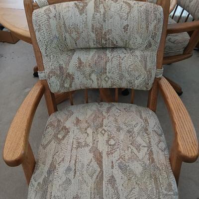 Beautiful drop leaf Oak pedestal table with three upholstered chairs on casters