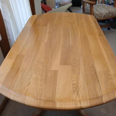 Beautiful drop leaf Oak pedestal table with three upholstered chairs on casters