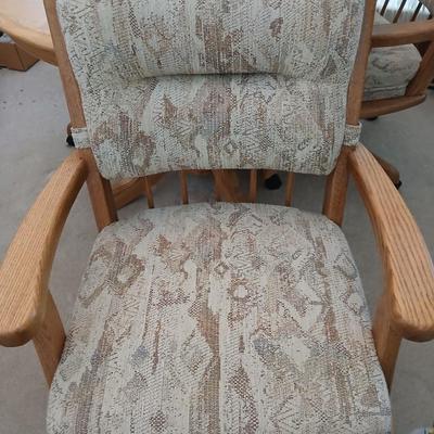 Beautiful drop leaf Oak pedestal table with three upholstered chairs on casters