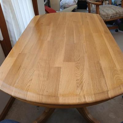 Beautiful drop leaf Oak pedestal table with three upholstered chairs on casters