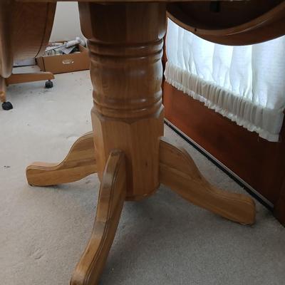 Beautiful drop leaf Oak pedestal table with three upholstered chairs on casters